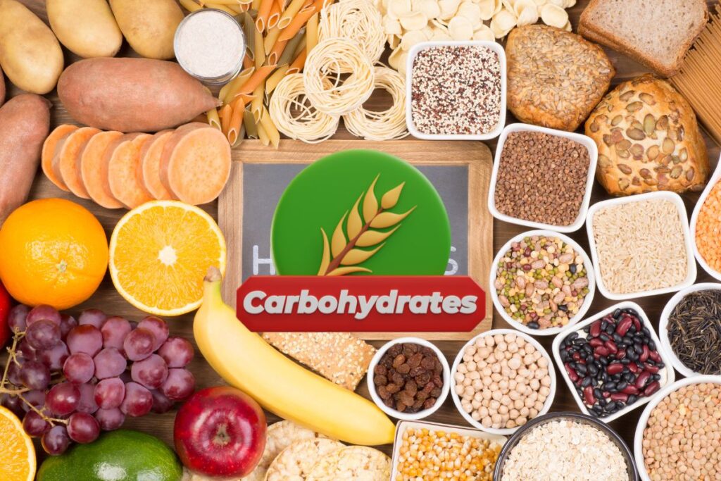 A variety of carbohydrate-rich foods including fruits, grains, legumes, and vegetables, with a 'Carbohydrates' label in the center.